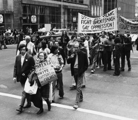 Jeanne Manford, center, with her son, Morty Manford, left, at the Christopher Street Liberation March in 1973, the precursor to today’s Annual Gay Pride March. Dr. Benjamin Spock, with glasses, is directly behind Morty.  image c/o PFLAG National